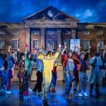 The cast of Back to the Future The Musical sing and dance with a ghetto blaster and in typical 80's attire