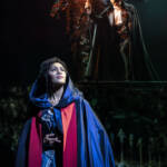 Christine holds a lantern out